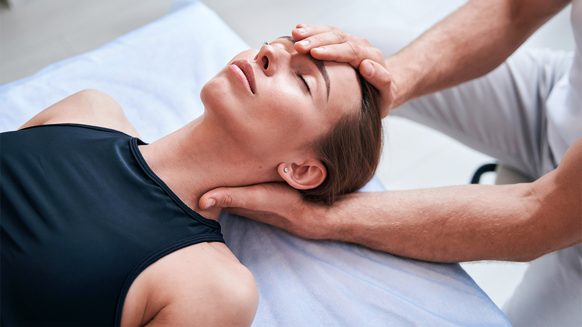 Physiotherapist treating neck and spine after whiplash injury